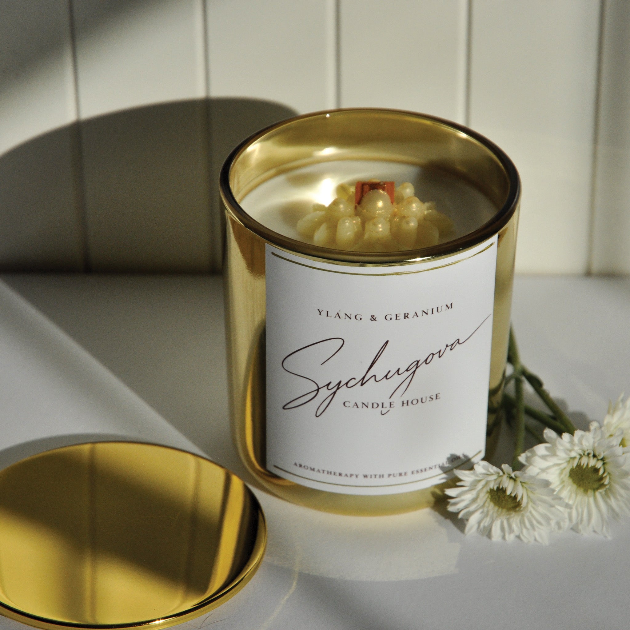 Close-up of the Ylang and Geranium Emotional Balance candle wax with dried botanical detail