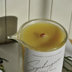 Close-up of the chamomile and lavandin massage candle with melted body oil texture and wood wick